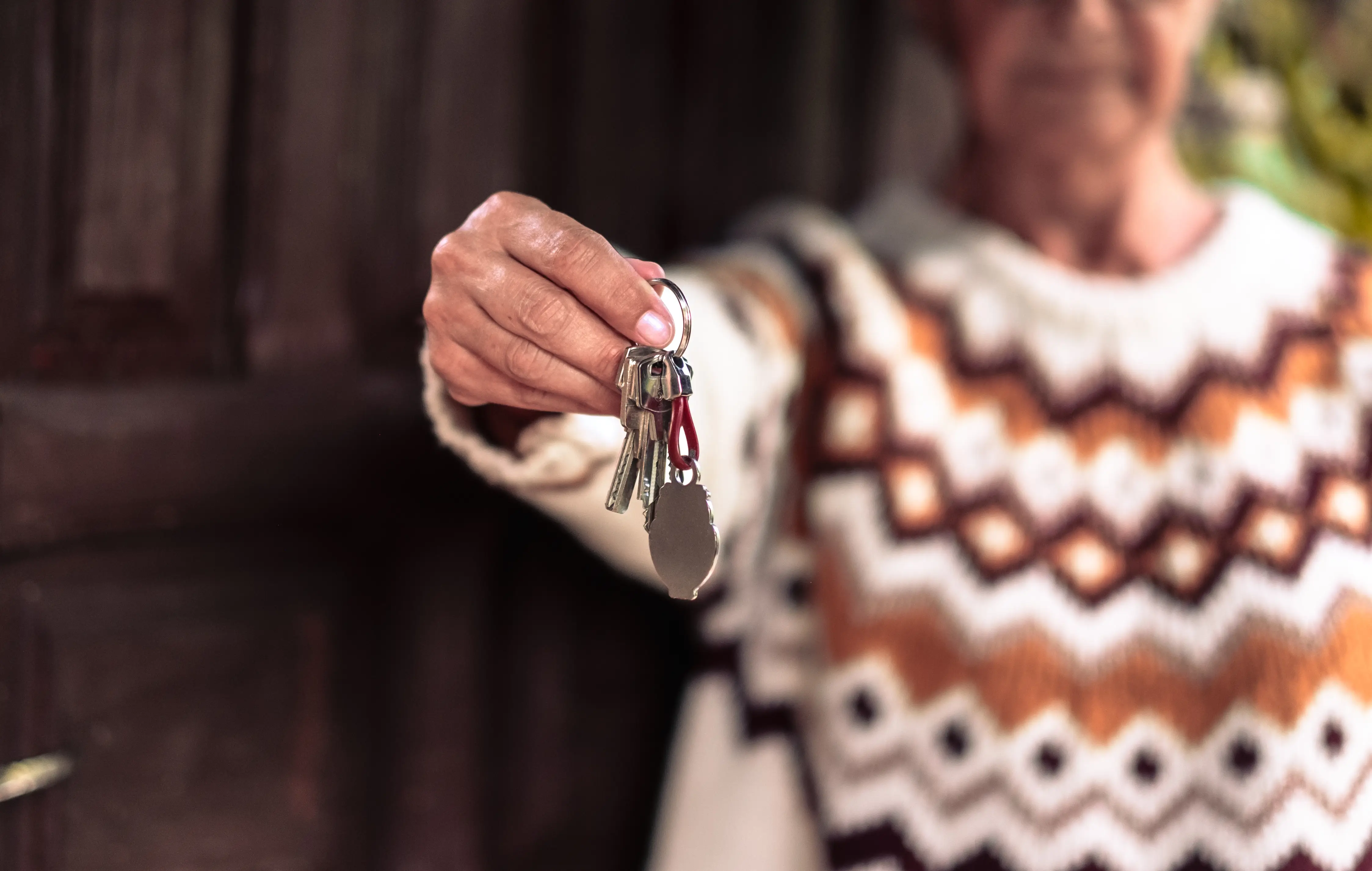 Glückliche Kundin hält ihre Schlüssel, nachdem der Schlüsseldienst ihr zur Not geholfen hat